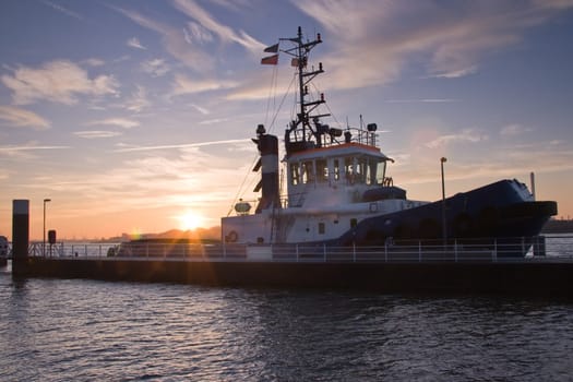 tug at sunrise just before leaving port