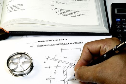 Engineering Design Calculation and Tools concept with book formulas and calculator