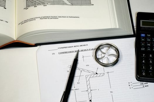 Engineering Design Calculation concept showing formulas and tools and parts