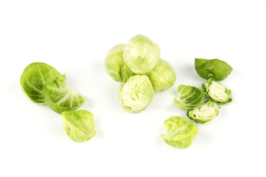 Small raw green sprouts peeled with leaves on a reflective white background