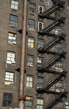 Old brick house with black iron staircase.