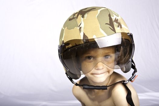 Boy in studio with helmet on against white background