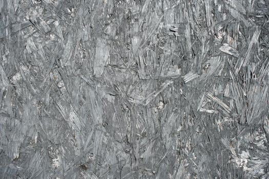 Chipboard background. Texture of gray material composed of wood shavings. 