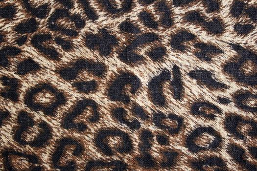 Leopard spotted fabric background. Cheetah fur pattern.