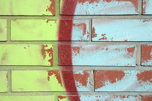 Colorful graffiti on a brick wall, and peeling paint.