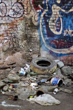 An abandoned area that is covered with trash and street graffiti.  This makes an excellent background or backdrop.  Shallow depth of field.