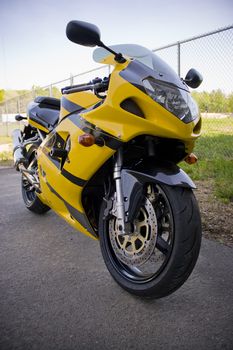 A brand new yellow motorcycle - modern day crotch rocket. 