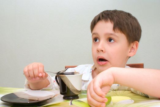 boy at the table looks surprised