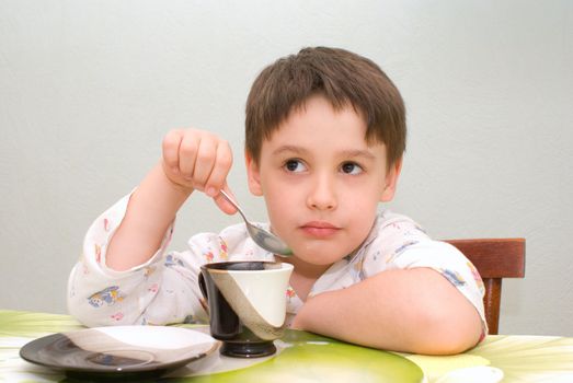 boy is having breakfast at the table