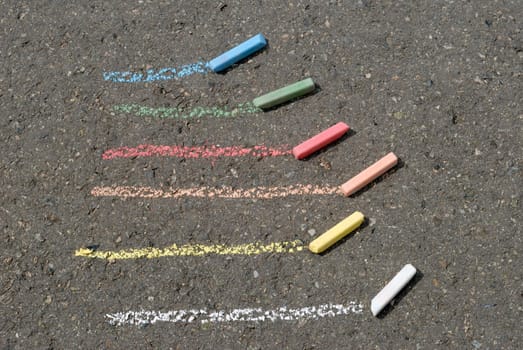 color lines and crayon at asphalt