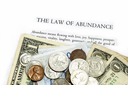 Law of Abundance text with currency notes and coins