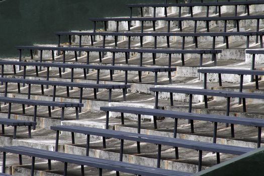 Blue Benches On A Grey Concrete Ground In Rows, Stadium Seats