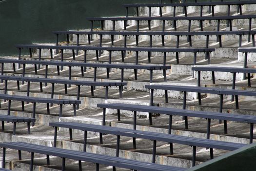 Blue Benches On A Grey Concrete Ground In Rows, Stadium Seats
