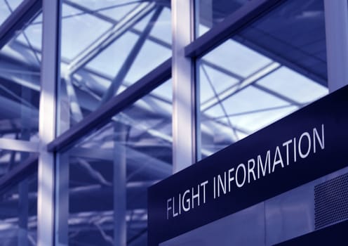 Flight Information Sign, Glass Facade Of An Airport Interior, Blue Toning