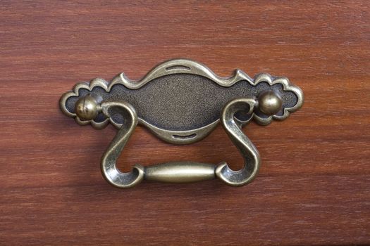 close-up of an antique drawer handle