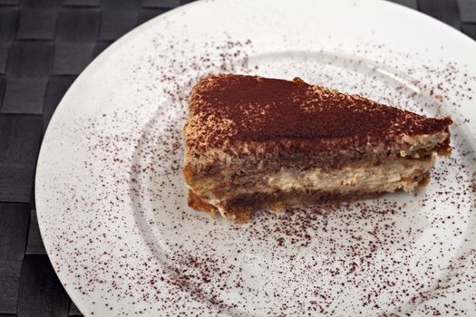 slice of a tiramisu cake on a white plate