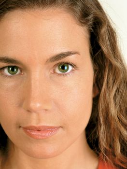 Closeup of a naturally beautiful woman with green eyes.
