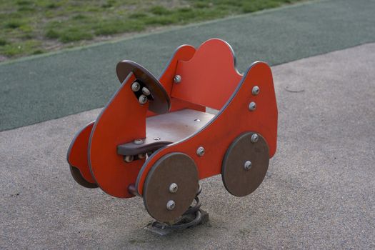 red wooden car from playground