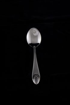 tea-spoon on black background