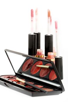 Group of lip glosses and lipsticks on isolated background