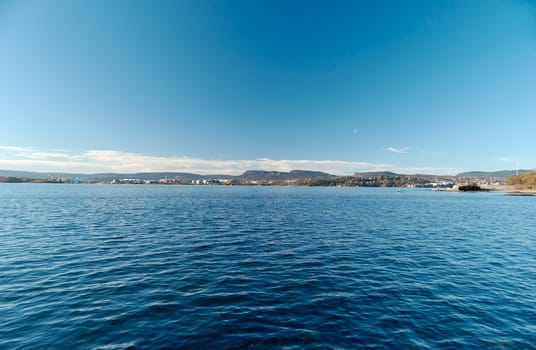 Fish-eye view over Oslo Fjord, looking at Bygøy and Fornebu. Sky and water are filter-polarised.
