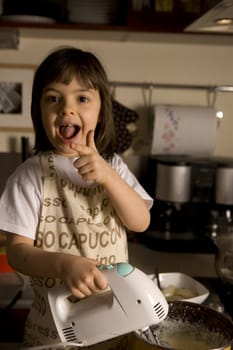  young girl having fun in the kitchen making cookies