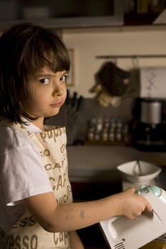  young girl having fun in the kitchen making cookies