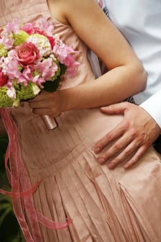 The groom gently embraces the bride