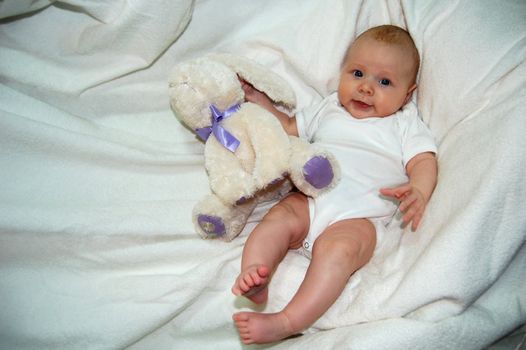 Lovely baby with  blue eyes, palming bunny - toy