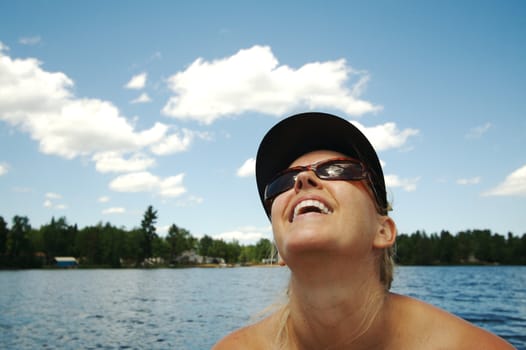 Beautiful woman enjoys a summer day on the lake.