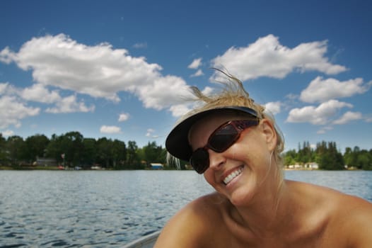 Beautiful woman enjoys a summer day on the lake.