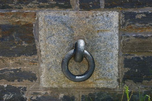 A large iron ring in a stone wall