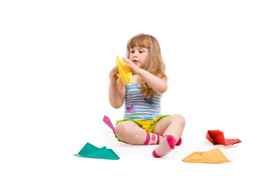 baby playing with made-hands paper airplane