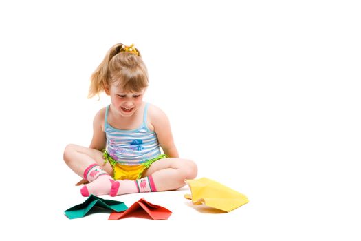 baby playing with made-hands paper airplane and very happy from her work