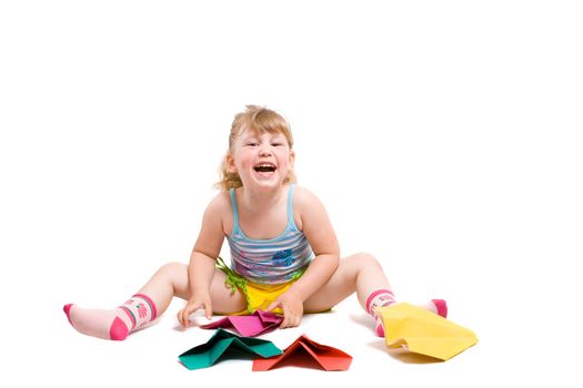 baby playing with made-hands paper airplane and very happy from her work