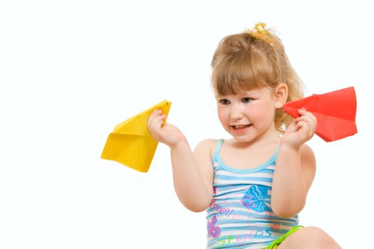 a small baby plaing with red and yellow paper airplane made hands