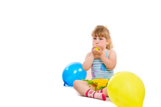 a small baby seat on the flow and inflate a rubber balls of differents colors