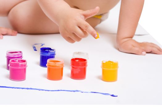 a small baby finger take color paint from tube