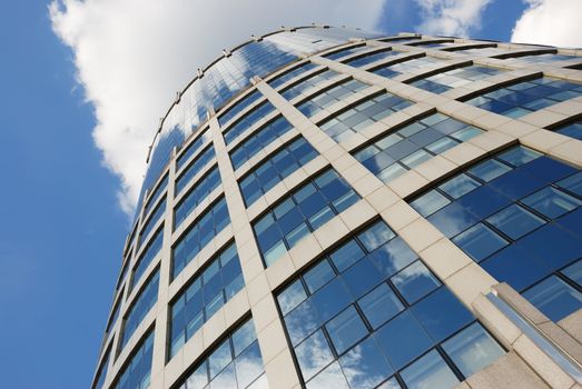 windows of a shiny skyscraper reflecting clouds