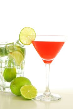 red and cold alcoholic drink with green lime