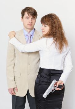 A young man and a beautiful woman with gun in hand