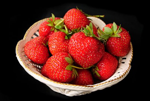 macro of strawberries against black