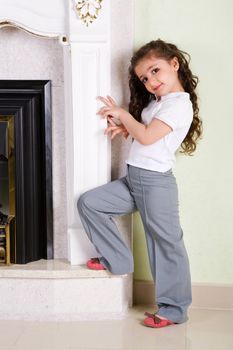 girl stands near the ancient fireplace