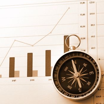 business concept with compass and diagram or chart