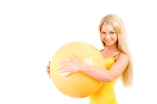 long haired smiling blond beauty with ball for fitness