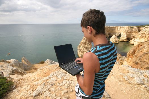 man working with laptop on the coast