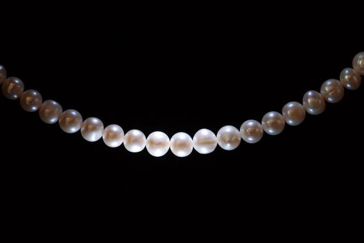 White pearl thread isolated on black background