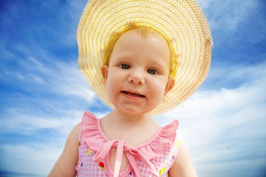 portrait of the small girl in straw hat
