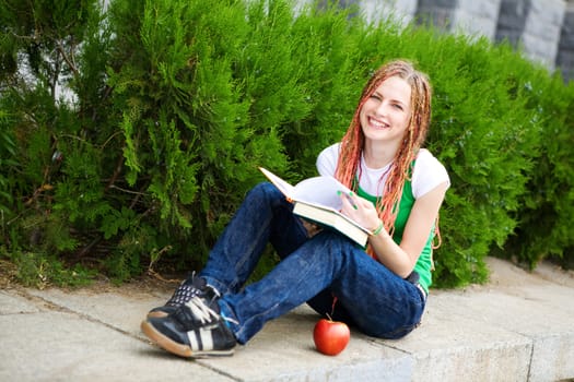 girl with a book near the school