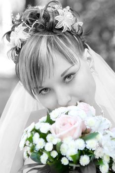 bride in black and white with a flower bouquet in color